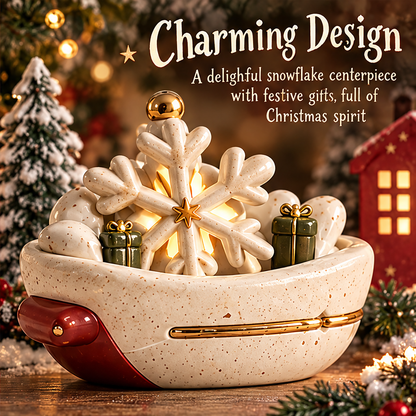 Angled front view of the glowing snowflake centerpiece with green gift-box details, a red accent and gold-tone trim.